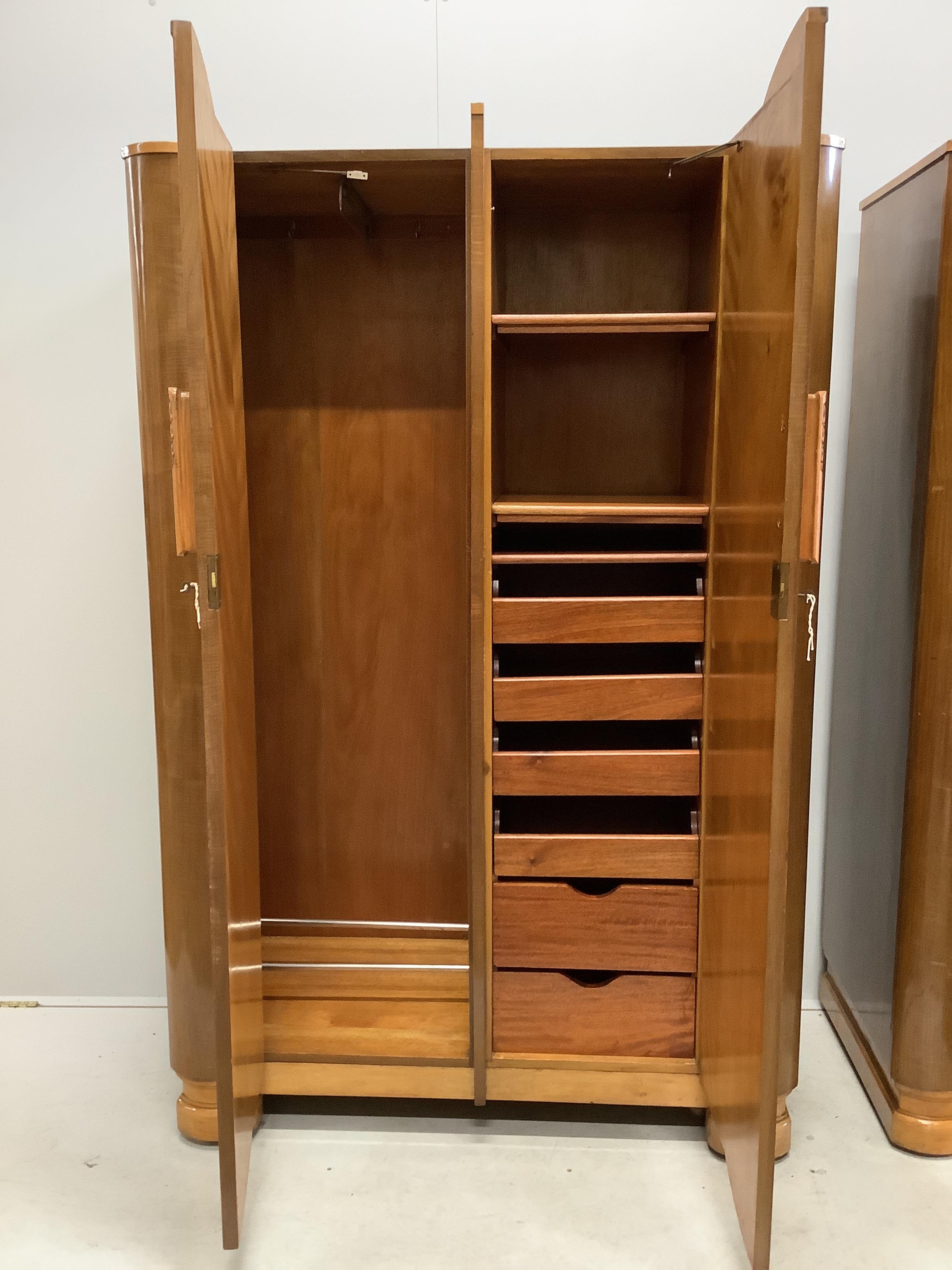 A pair of Art Deco walnut compactum wardrobes, width 116cm, depth 54cm, height 183cm